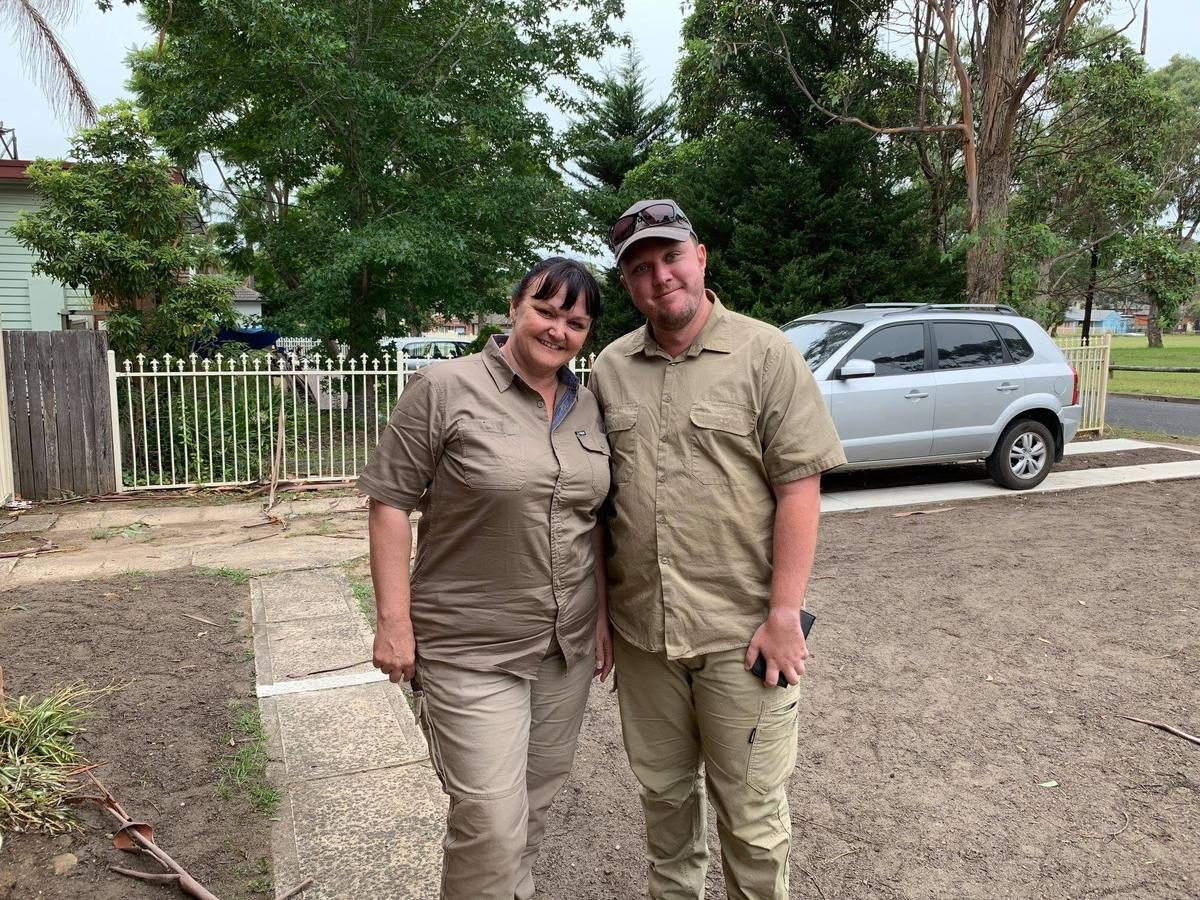 Two smiling Ground Control team members in khaki work uniforms